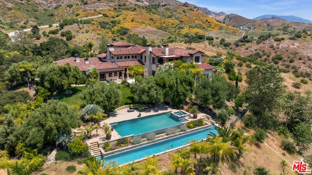 birds eye view of property with a mountain view