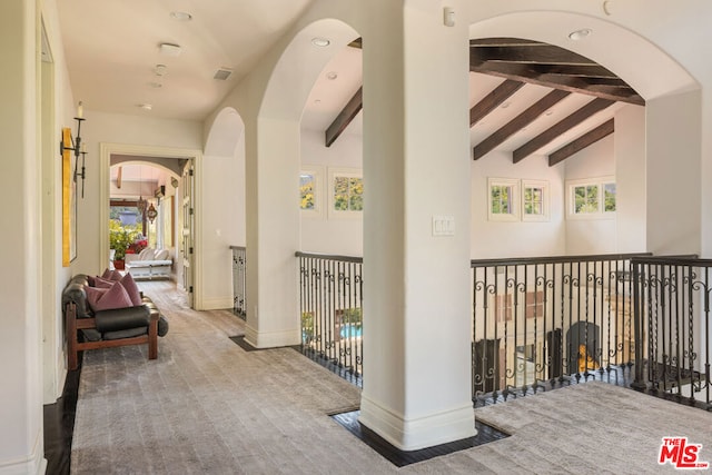 hall featuring hardwood / wood-style floors and lofted ceiling with beams