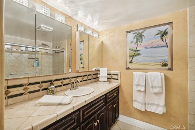 bathroom with decorative backsplash, vanity, and a shower with shower door