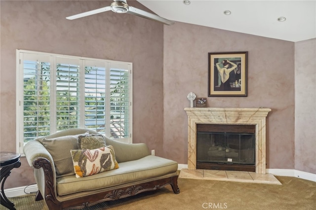 carpeted living room featuring lofted ceiling, ceiling fan, and a high end fireplace