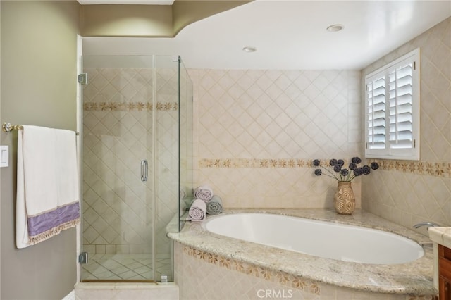 bathroom with shower with separate bathtub