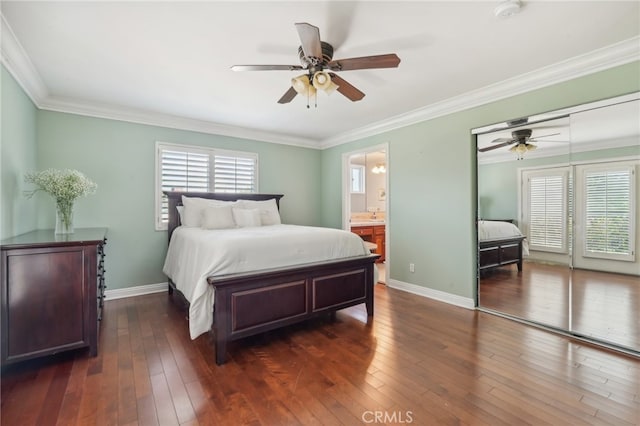 bedroom featuring ceiling fan, dark hardwood / wood-style floors, and multiple windows