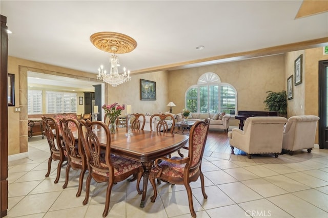 tiled dining area with a chandelier