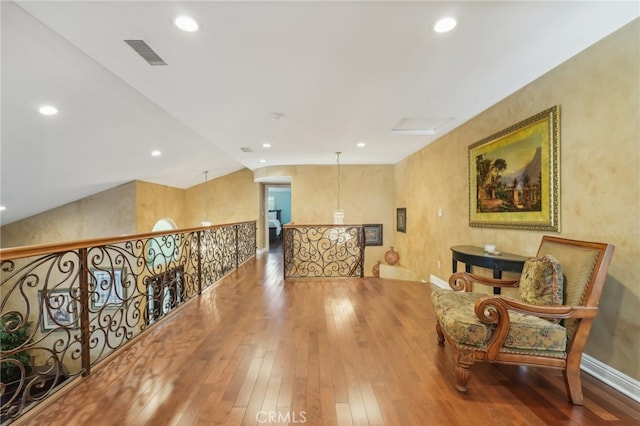 sitting room featuring hardwood / wood-style flooring and vaulted ceiling