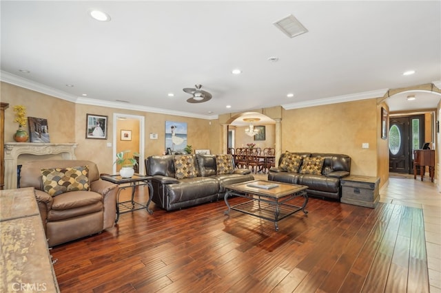 living room with ornamental molding and dark wood-type flooring