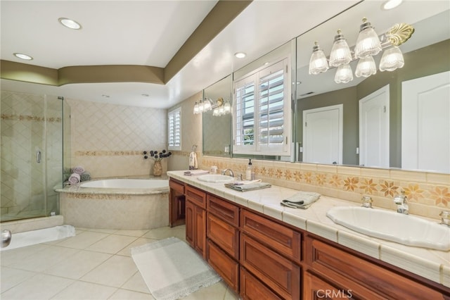 bathroom with shower with separate bathtub, tile patterned flooring, a notable chandelier, decorative backsplash, and vanity