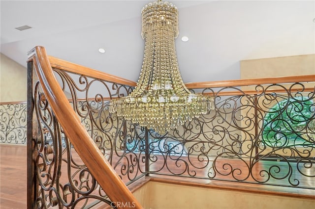 room details featuring a chandelier and hardwood / wood-style flooring