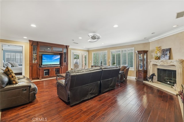 living room with ornamental molding, a fireplace, and dark wood-type flooring