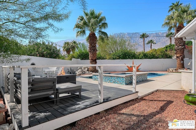 view of pool featuring an in ground hot tub and a mountain view