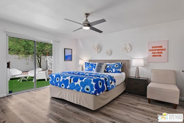 bedroom featuring access to outside, ceiling fan, hardwood / wood-style floors, and a textured ceiling