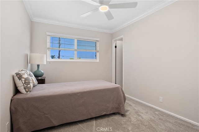 carpeted bedroom with ornamental molding and ceiling fan