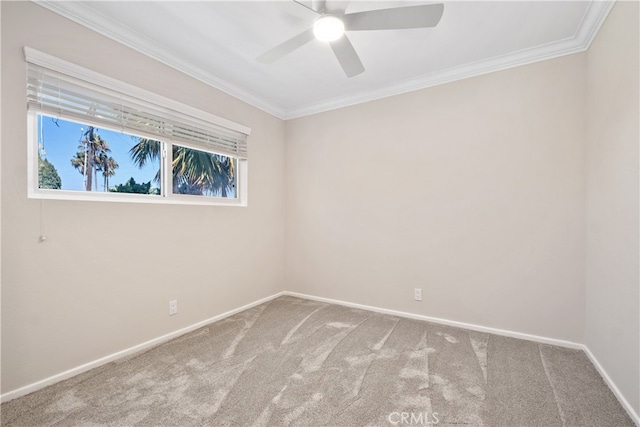 empty room with ornamental molding, carpet flooring, and ceiling fan