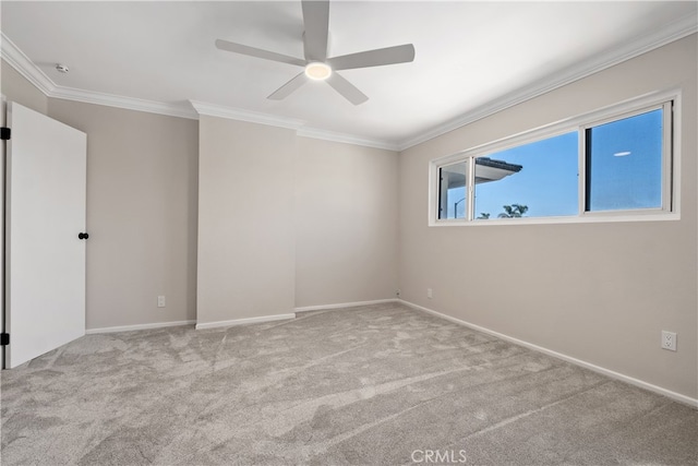 carpeted spare room with crown molding and ceiling fan