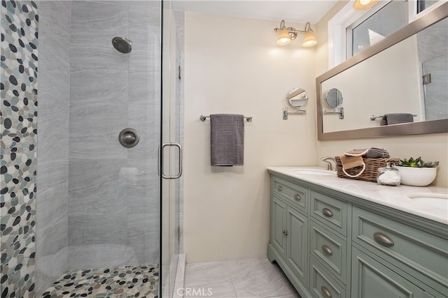 bathroom with vanity and a shower with door