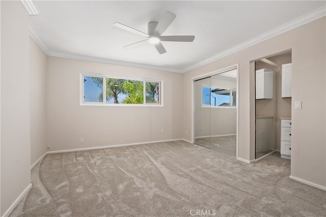 unfurnished bedroom with ceiling fan, crown molding, and light colored carpet