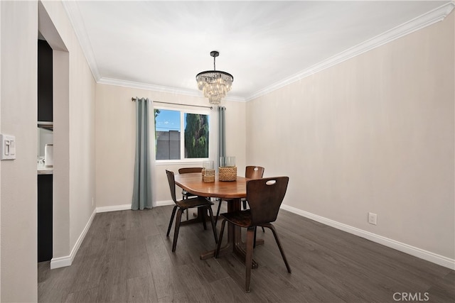 dining room with ornamental molding, a chandelier, and dark hardwood / wood-style floors