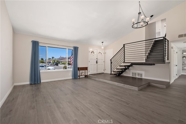 foyer entrance featuring an inviting chandelier and dark hardwood / wood-style floors