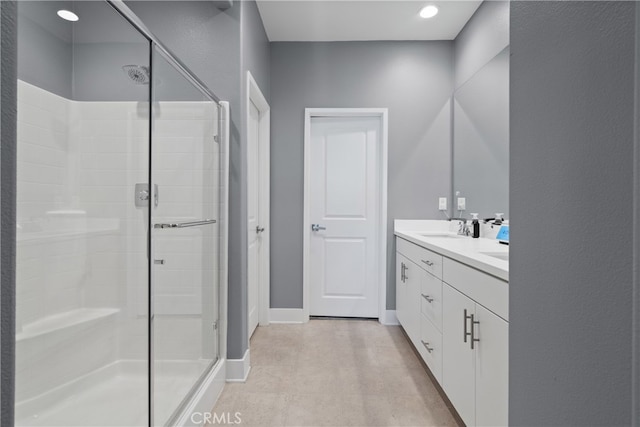 bathroom with walk in shower and vanity