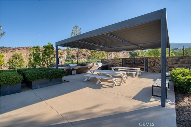 view of patio with a mountain view and a grill