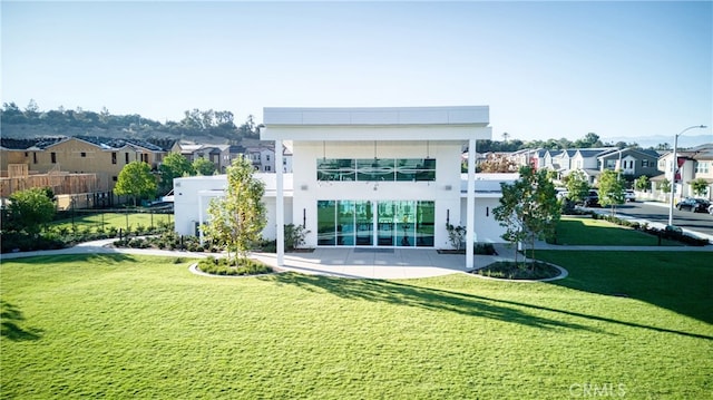 rear view of property with a lawn