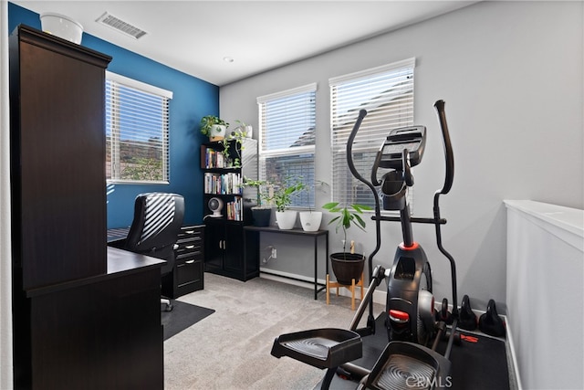 workout room featuring light carpet