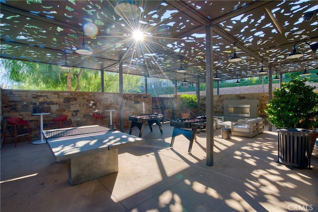 view of patio / terrace with an outdoor living space with a fire pit