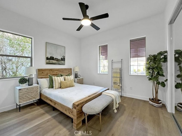 bedroom with ceiling fan and hardwood / wood-style floors