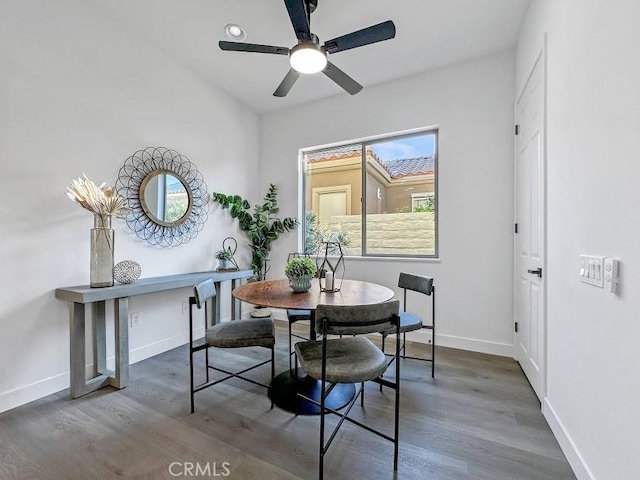 dining area with ceiling fan, plenty of natural light, and dark wood-type flooring