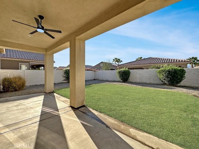 view of yard featuring ceiling fan and a patio