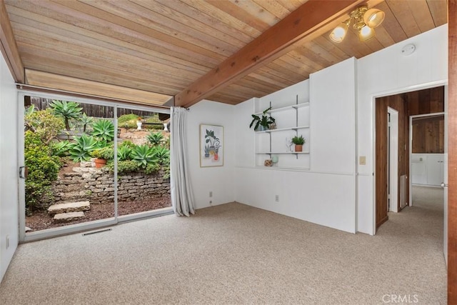 carpeted empty room featuring beamed ceiling and wooden ceiling