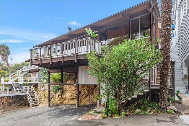 view of property exterior with a deck