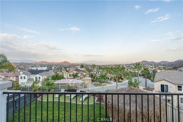 balcony at dusk featuring a mountain view