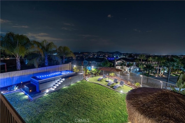 pool at night with a yard