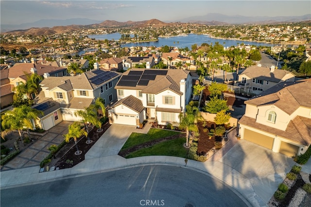 drone / aerial view featuring a water and mountain view