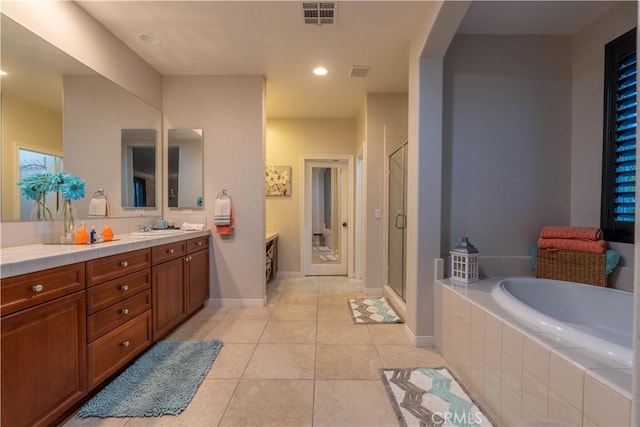 bathroom with tile patterned flooring, vanity, and independent shower and bath