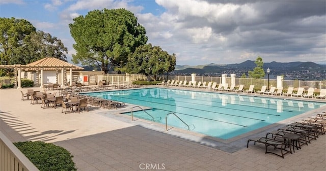 view of swimming pool featuring a mountain view and a patio area