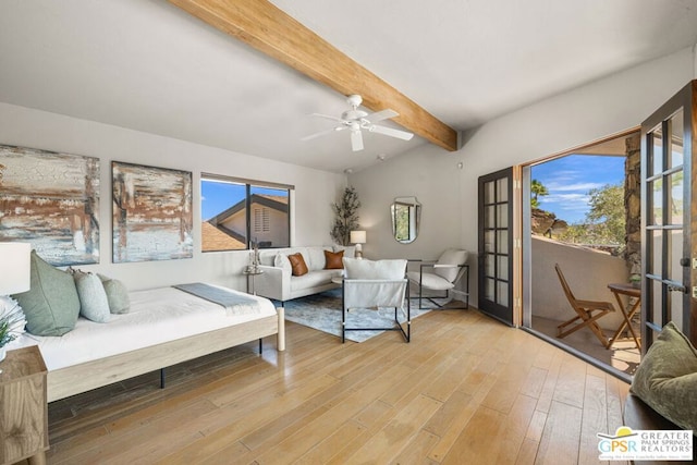 bedroom featuring ceiling fan, multiple windows, hardwood / wood-style flooring, and vaulted ceiling with beams