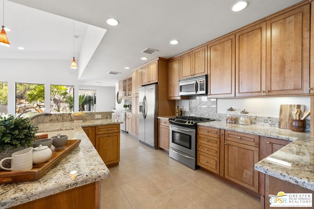 kitchen featuring decorative light fixtures, backsplash, light stone counters, and stainless steel appliances