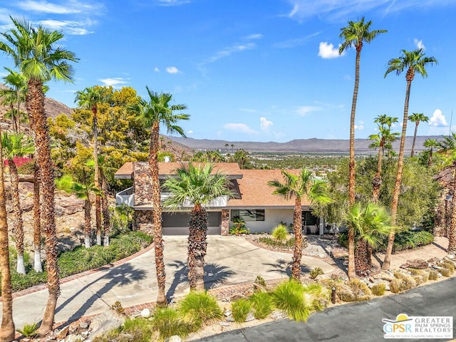 view of front of house with a garage and a mountain view