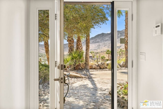 doorway to outside featuring a mountain view