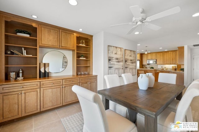 tiled dining space with ceiling fan