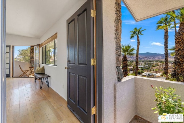 doorway to property with a balcony and a mountain view