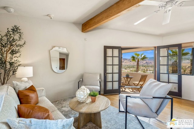 sitting room with ceiling fan, french doors, beamed ceiling, and light hardwood / wood-style floors