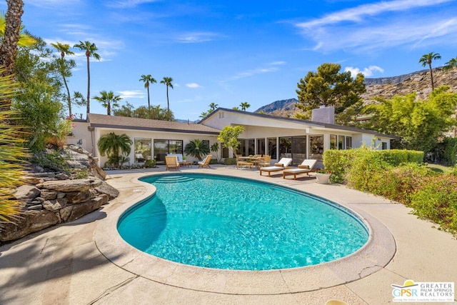 view of pool featuring a patio area and a mountain view