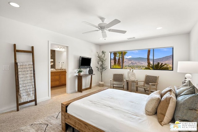 carpeted bedroom with ceiling fan and ensuite bathroom