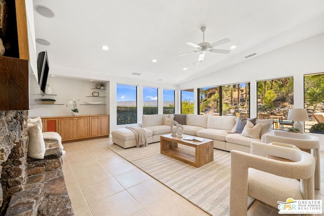 tiled living room with a healthy amount of sunlight, lofted ceiling, and ceiling fan