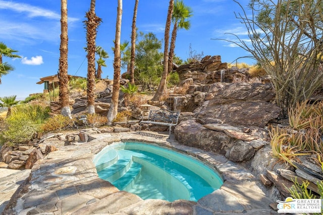 view of pool featuring a jacuzzi