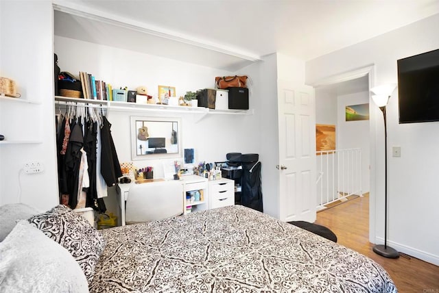 bedroom featuring wood-type flooring and a closet