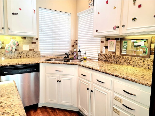 kitchen with light stone counters, sink, dark hardwood / wood-style flooring, white cabinetry, and dishwasher