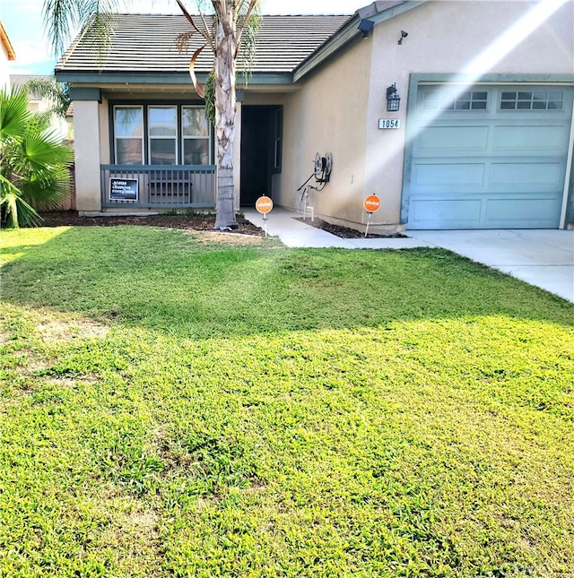 ranch-style home featuring a garage and a front lawn